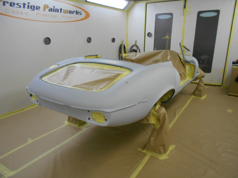 Jaguar E-type paintwork - outer body masked ready for colour