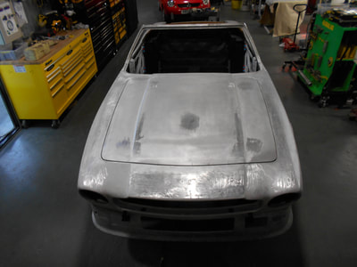 Aston Martin V8 Restoration -
front clip and bonnet offered back on